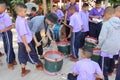 Asian teacher is teaching the music note for student group.